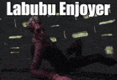 a man in a suit is crawling on the floor with the words labubu enjoyer written above him