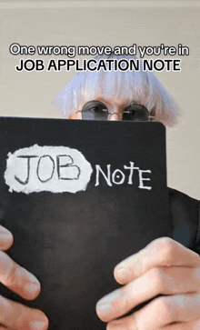 a person is holding a job application note in their hand