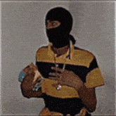 a man wearing a mask and a striped shirt
