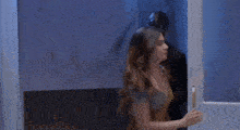 a man and woman are standing next to each other in a room .