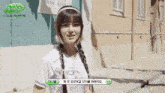 a girl with braids is standing in front of a building that says making gems