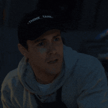 a man wearing a hat that says think tank