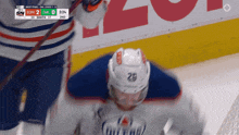 a hockey player with the number 29 on his helmet stands on the ice