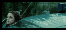 a woman sitting in a car with a box on top of her head