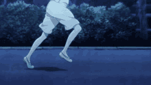 a person wearing white shorts and white shoes is running in the dark