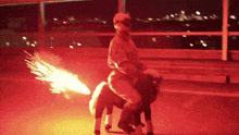 a man is riding on the back of a pony with fireworks coming out of its tail .