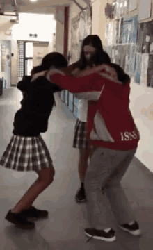 a person wearing a red jacket with the word isns on the back
