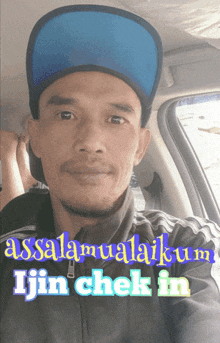 a man wearing a blue hat with the words assalamualaikum ijin chek in behind him