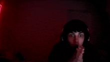 a blurry picture of a man holding his head in the dark .