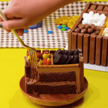 a person is holding a fork over a slice of chocolate cake