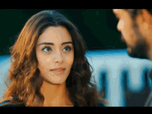 a close up of a woman 's face with a man behind her