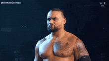 a man with a tattoo on his chest stands in front of a screen that says thekamdreesen