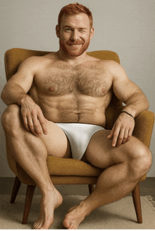 a shirtless man in white underwear is sitting in a chair