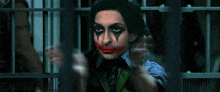 a man in a prison cell with a joker face painted on his face