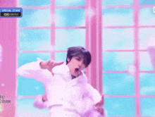 a man in a white shirt is dancing on a stage with a special stage sign above him