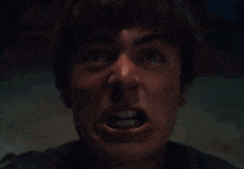 a close up of a man screaming with his mouth wide open
