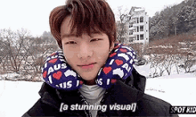 a young man wearing a neck pillow is standing in the snow and looking at the camera .