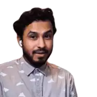 a man with a beard is wearing headphones and a shirt with a pattern of planes on it .
