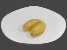 a piece of paper is laying on a white surface next to a yellow object