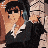 a man wearing sunglasses and a suit is carrying a bag on his shoulder .