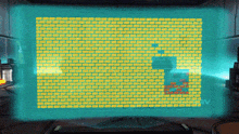 a computer screen displays a brick wall with the letter r in the middle