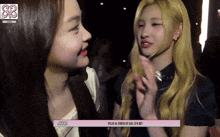 two girls are looking at each other and one of them has a pink box that says jimin on it
