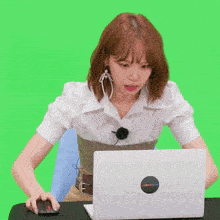 a woman is sitting in front of a laptop with a sticker on it that says ' netflix '