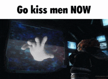 a cartoon hand is projected on a screen with the words go kiss men now below it