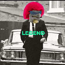 a man in a suit and tie is standing in front of a car with the word legend on it