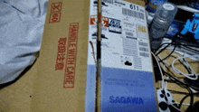a cardboard box that says handle with care sits on a table
