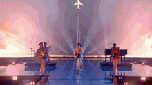 a group of people are playing instruments on a stage with an airplane in the background