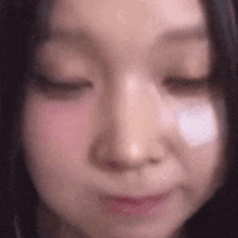 a close up of a woman 's face with her eyes closed and a white patch on her cheek .
