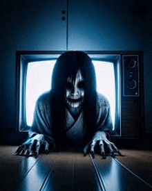 a scary woman is crawling out of a television and looking at the camera .