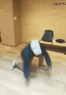 a person wearing a virtual reality headset is doing a handstand on the floor