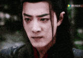 a close up of a man 's face with chinese characters on the bottom right
