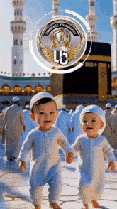 two babies are walking in front of a mosque holding hands and smiling .