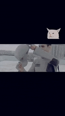 a man is smiling with a cat on the bottom right