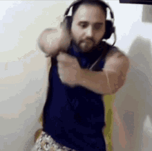 a man with a beard is wearing headphones and a microphone .