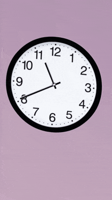 a black and white clock on a purple background shows the time as 5:05
