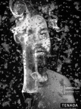 a black and white photo of a man with smoke coming out of his face and the words tenada on the bottom
