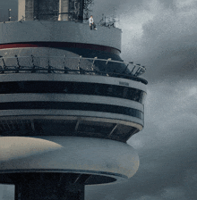 a man is standing on top of a very tall building