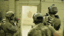 a group of soldiers are standing in front of a door that has a sticker on it