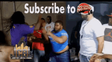 a group of men are dancing in front of a sign that says subscribe to jcbl