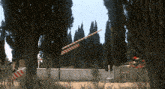 a red white and blue striped flag is hanging from a pole in a cemetery