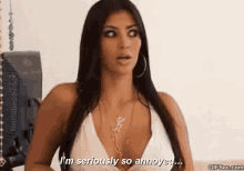 kim kardashian is wearing a white top and necklace and says i 'm seriously so annoyed .