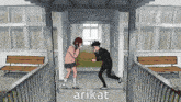a man and a girl are dancing in a hallway with the word arikat written on the bottom