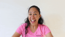 a woman in a pink shirt with fenua written on it