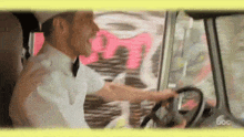 a man in a tuxedo is driving a car with abc written on the bottom