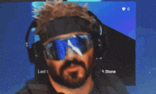 a man with a beard wearing sunglasses and headphones with the name frank stone on the bottom right