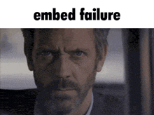 a close up of a man 's face with the words " embedded failure " above him